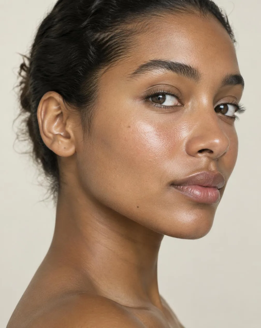 Editorial portrait of naturally glowing skin in soft daylight
